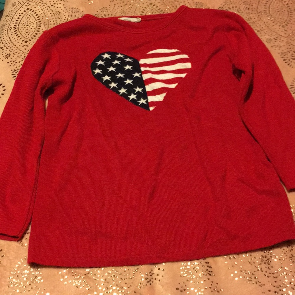 A red sweater with the heart of the American flag